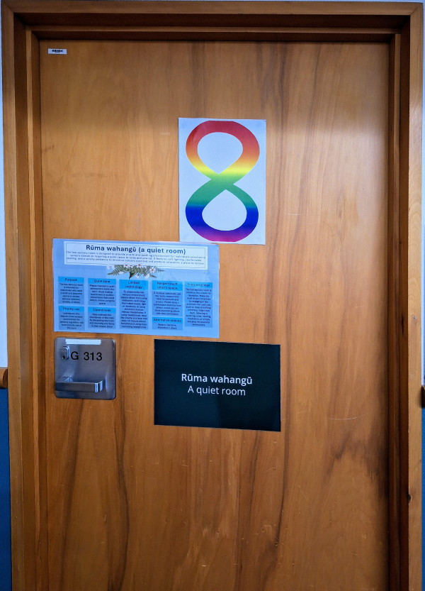 the quiet room door, featuring a rainbow neurodiversity symbol